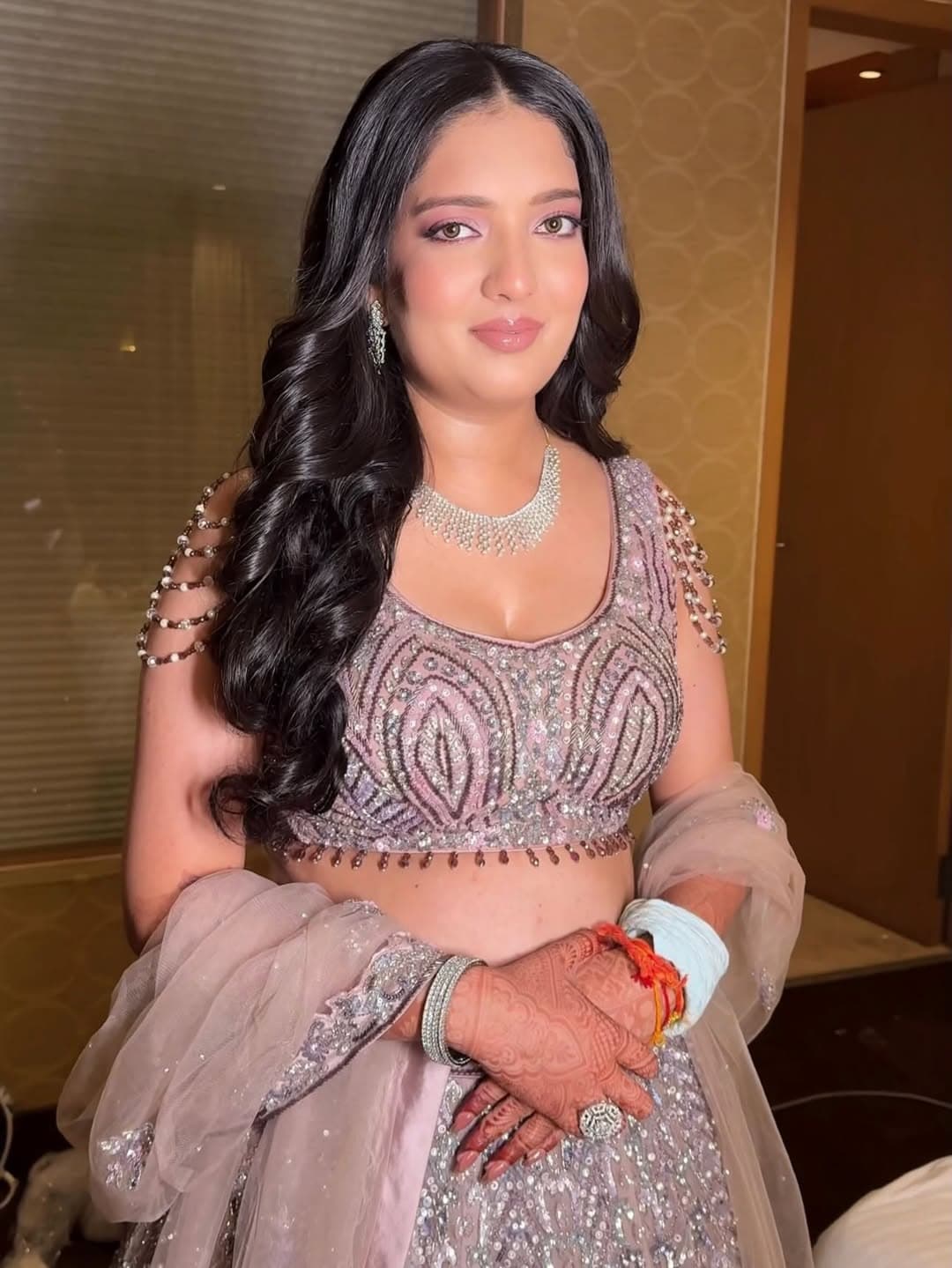 Wedding portrait in an ivory embellished outfit with cape-style shoulders, sheer sleeves, and delicate bridal henna